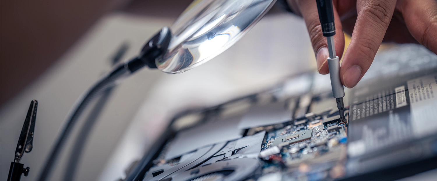 person soldering a piece of equipment