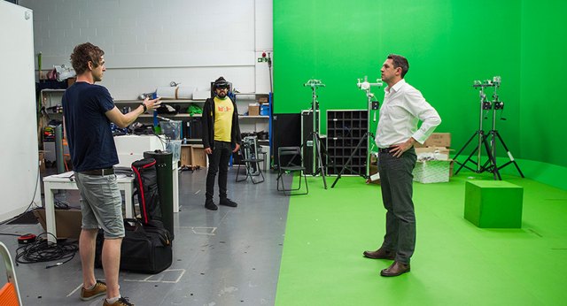 man speaking in front of greenscreen